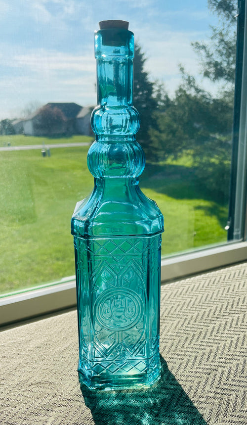Beautiful teal embossed glass bottle