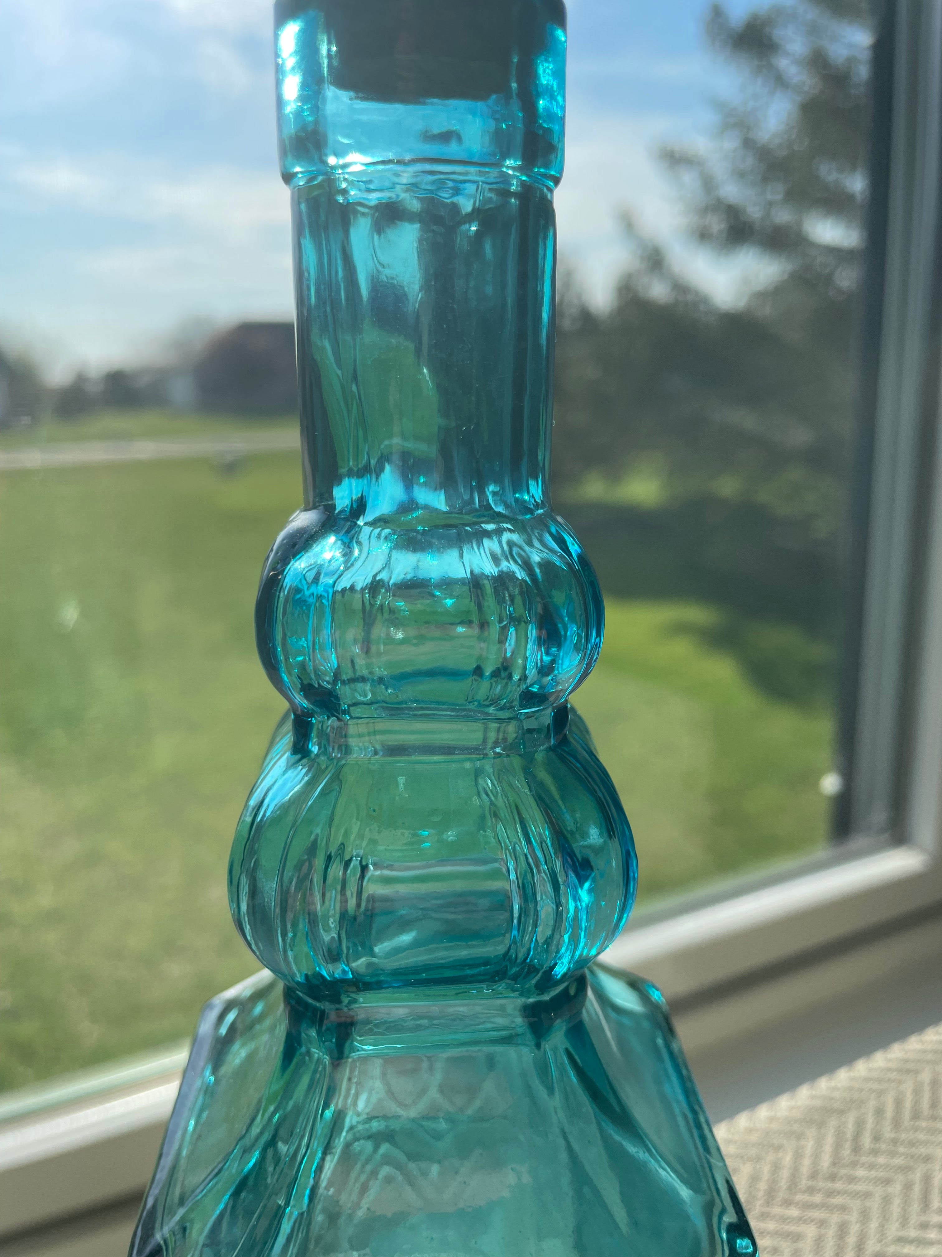 Beautiful teal embossed glass bottle