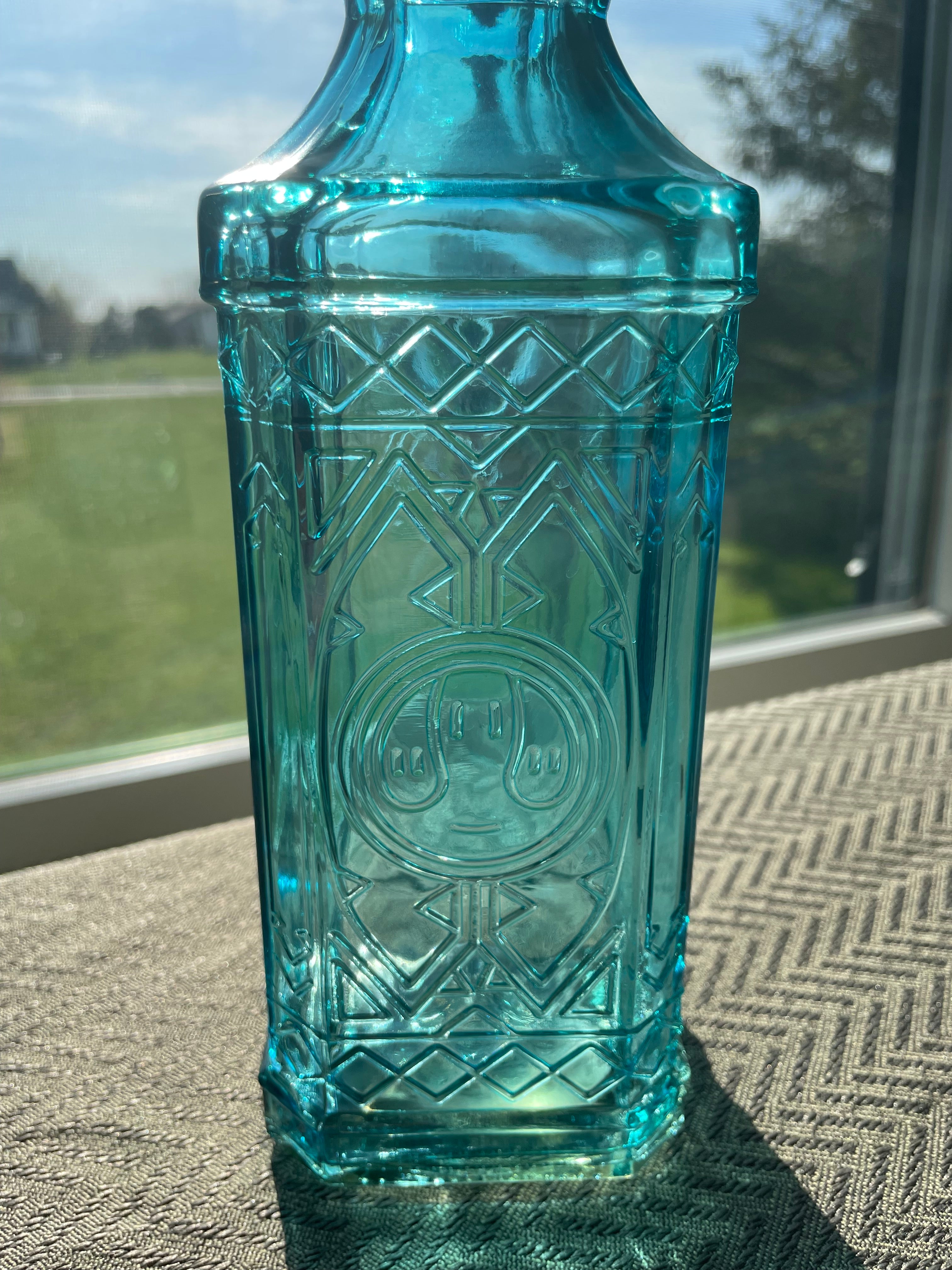 Beautiful teal embossed glass bottle
