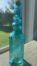 Beautiful teal embossed glass bottle