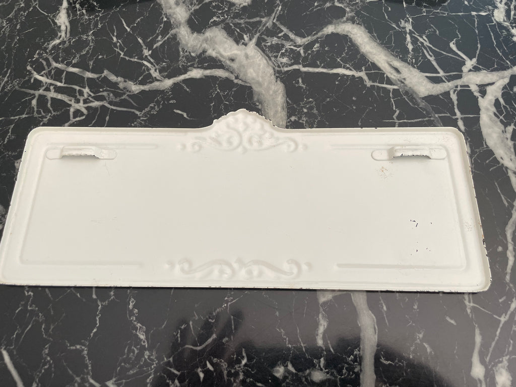 Cream colored "Inspire" metal sign