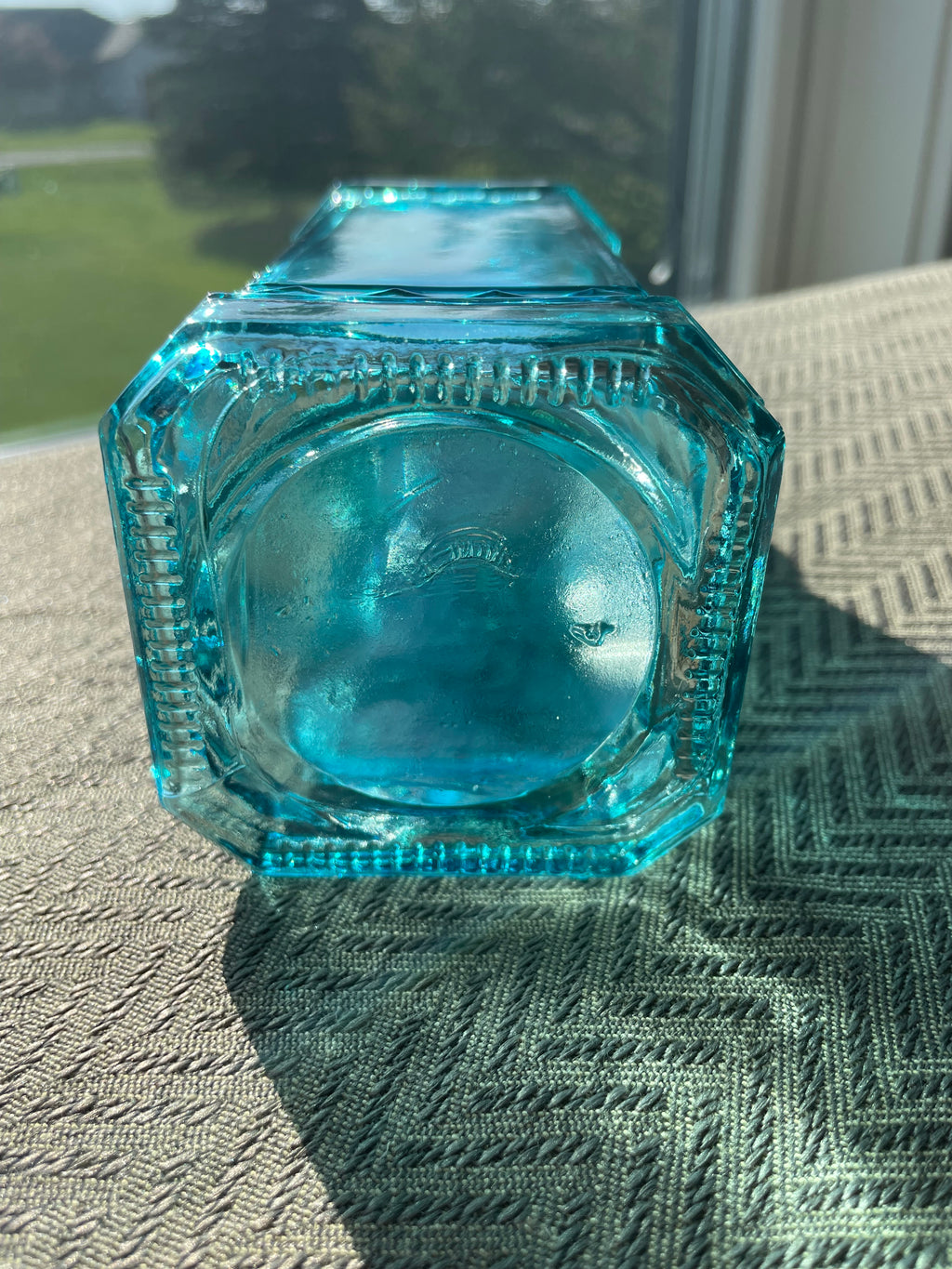Beautiful teal embossed glass bottle